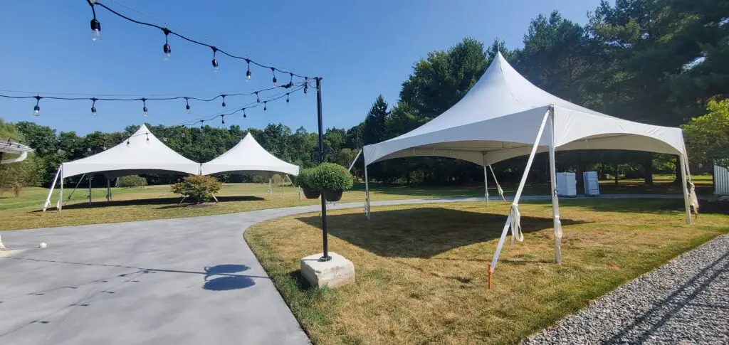 Two white tents on grassy area